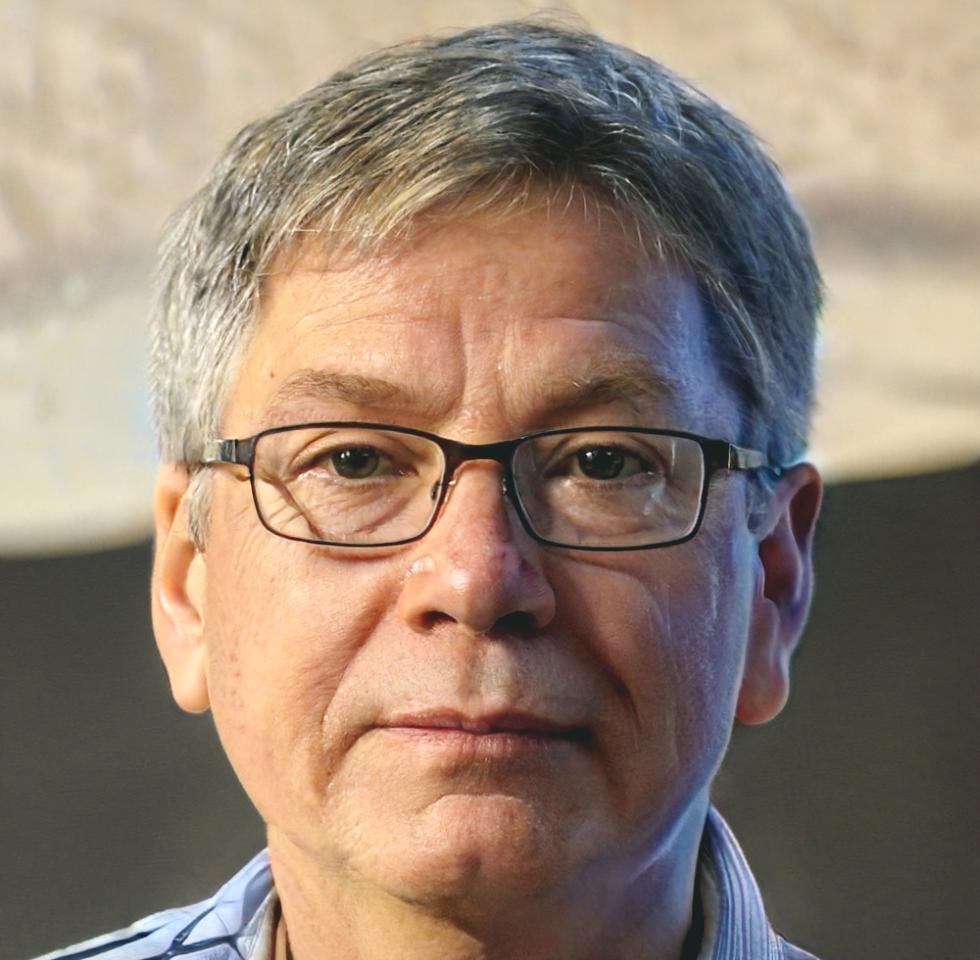 Business professional analyzing keyword performance data on laptop with focused concentration