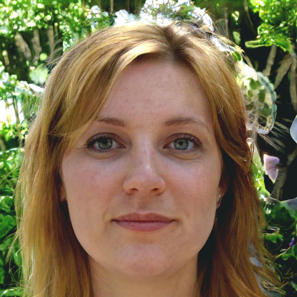 Professional woman reviewing keyword research results with satisfied expression